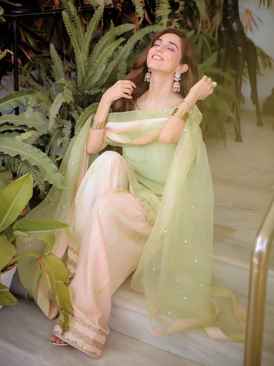 Serene Beauty: A Young Muse Adorned in Lush Green thumbnail 3