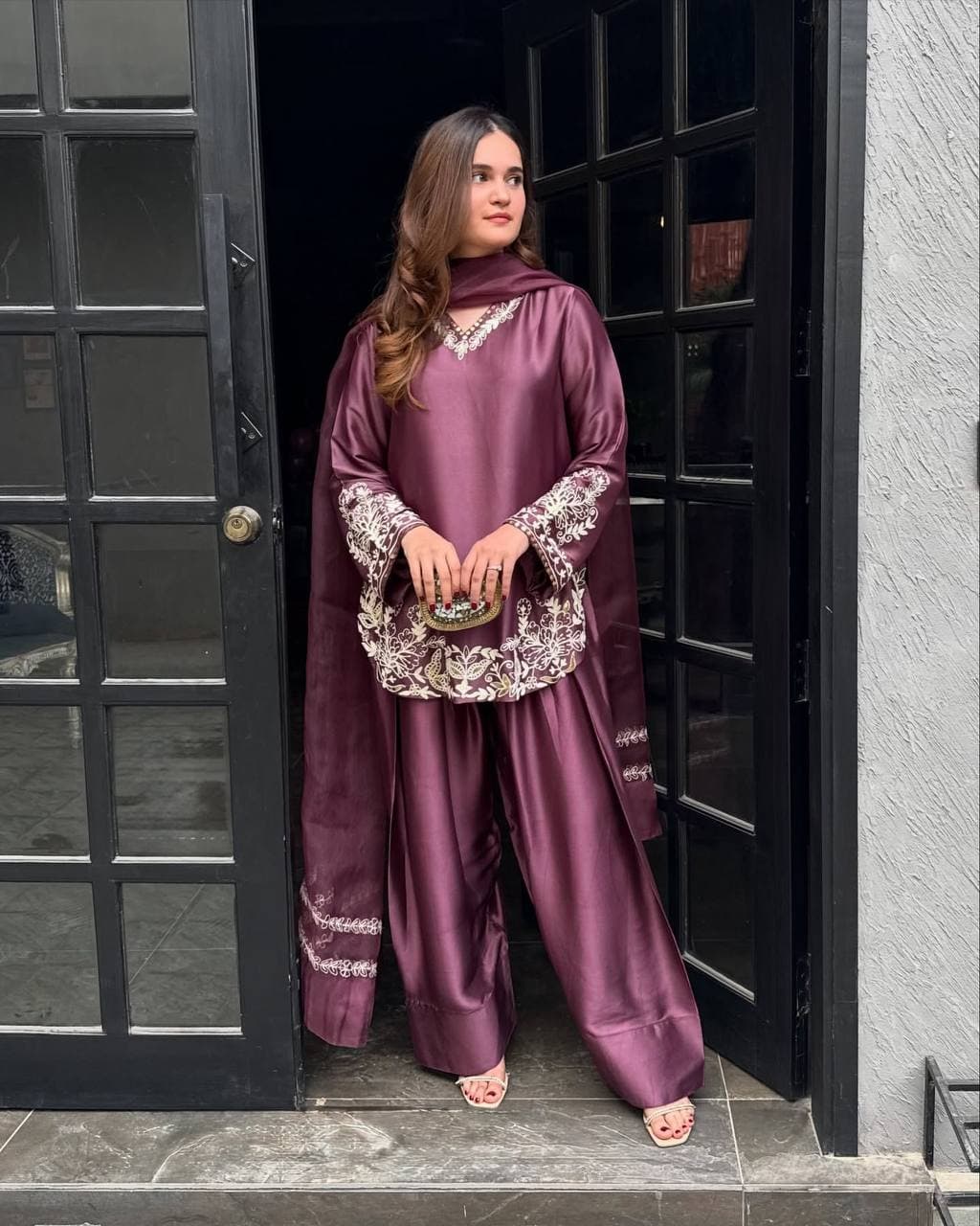 Majestic Aura: Woman in Wine Captivates at the Doorway